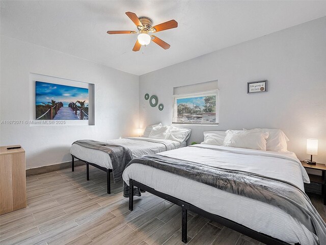 bedroom with light wood-type flooring and ceiling fan