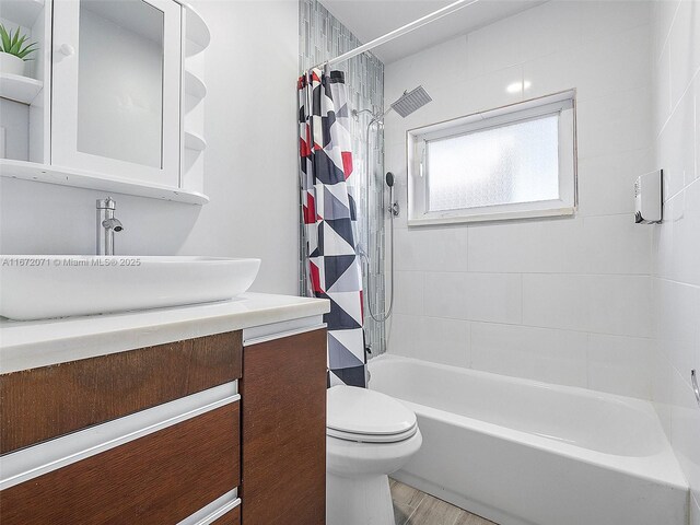 full bathroom featuring vanity, toilet, shower / bath combination with curtain, and hardwood / wood-style floors