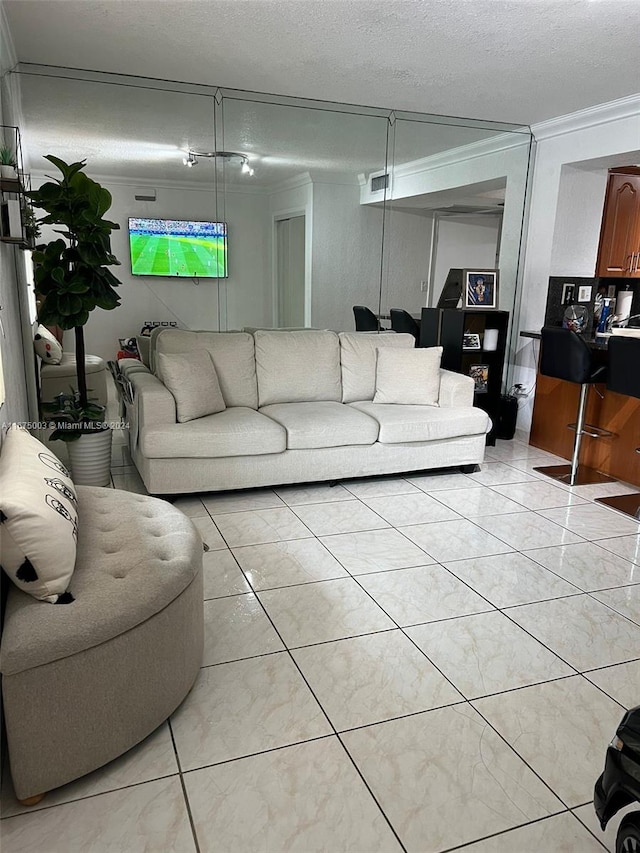 tiled living room featuring a textured ceiling and crown molding