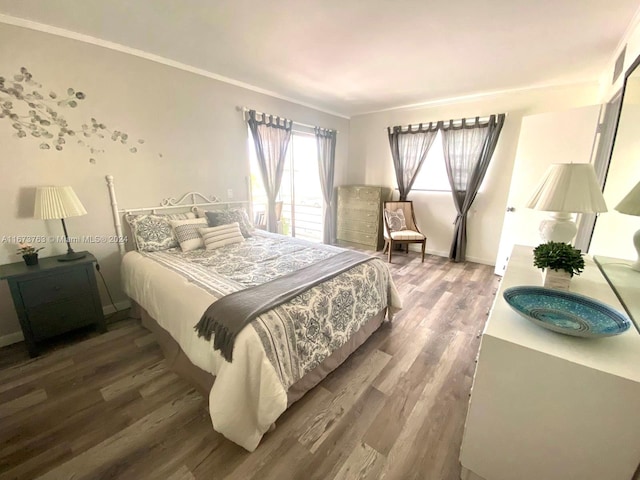 bedroom with crown molding and dark hardwood / wood-style flooring