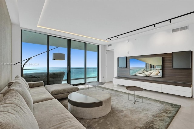 18975 Collins Ave Unit 2001, Sunny Isles Beach, FL 33160 - living room featuring a wall of windows, rail lighting, and a water view