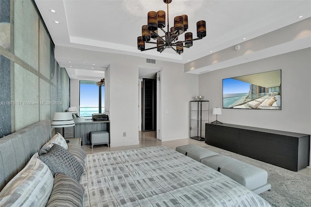 bedroom with an inviting chandelier and a tray ceiling