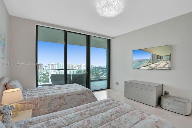 bedroom featuring access to outside, a chandelier, and floor to ceiling windows