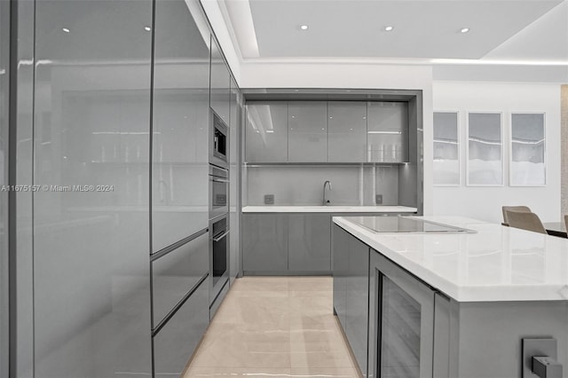 kitchen featuring beverage cooler, gray cabinets, and appliances with stainless steel finishes