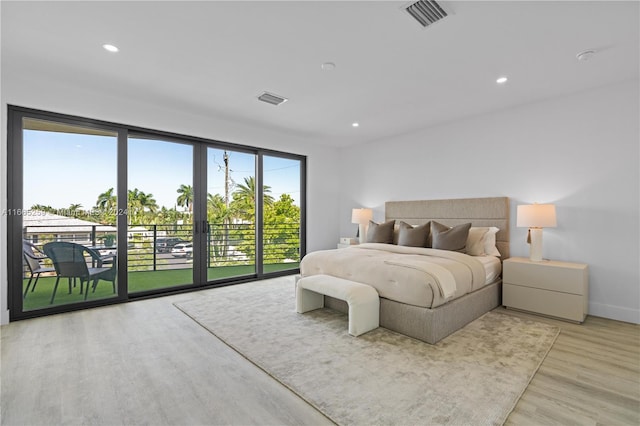 bedroom featuring light hardwood / wood-style floors and access to exterior