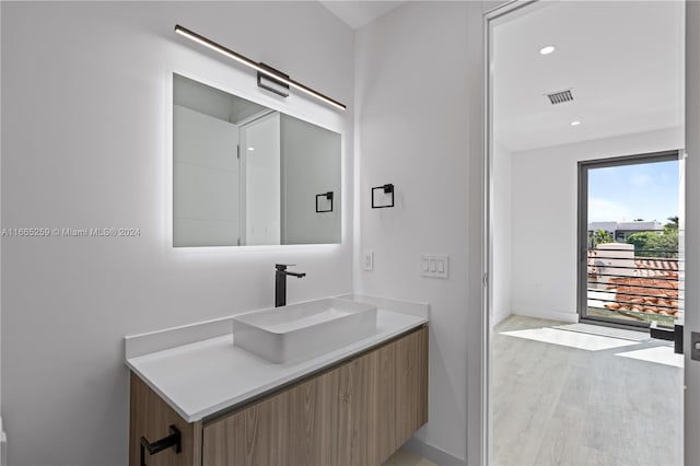 bathroom with vanity and hardwood / wood-style flooring