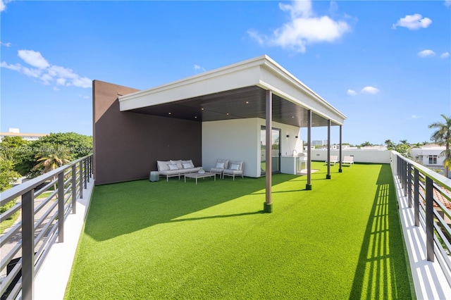 rear view of property featuring an outdoor hangout area and a balcony