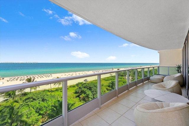 balcony featuring a water view and a view of the beach