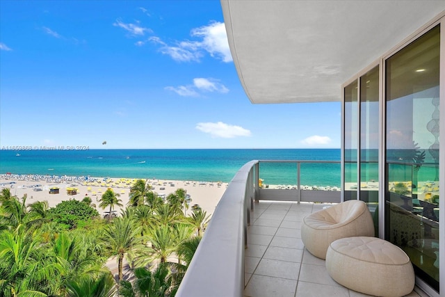 balcony featuring a water view and a view of the beach