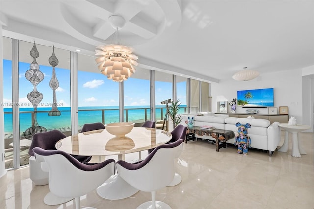 dining area with a water view and expansive windows