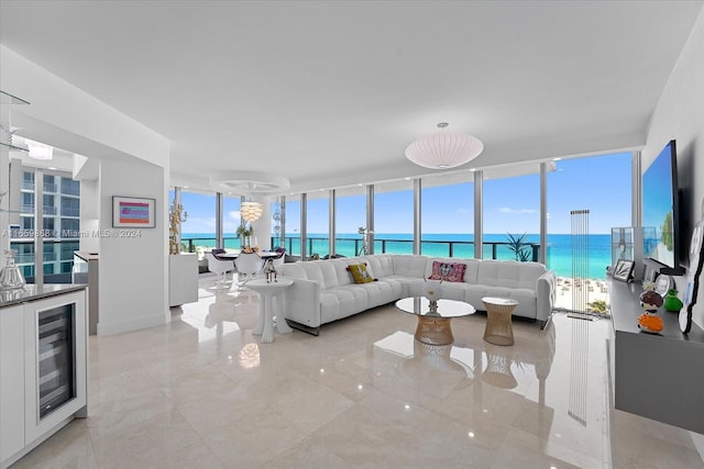 living room featuring beverage cooler, a wall of windows, and a wealth of natural light