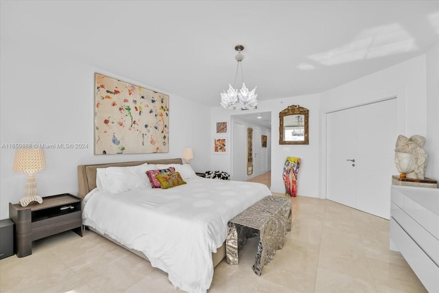 tiled bedroom with a closet and a chandelier