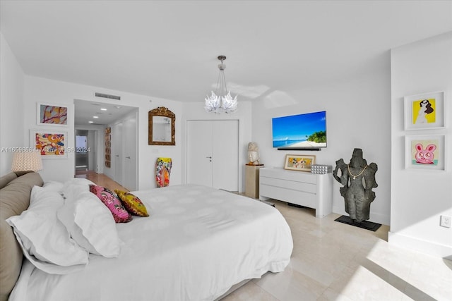 tiled bedroom featuring a notable chandelier