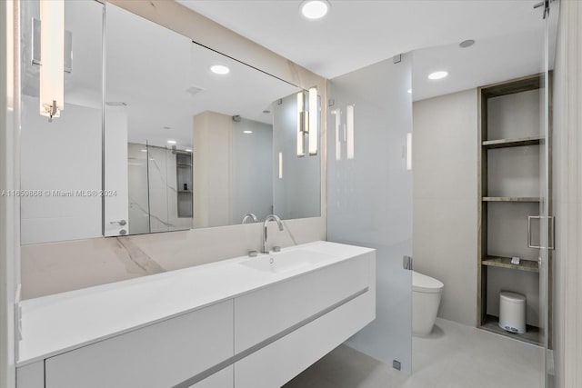 bathroom featuring tile patterned floors, vanity, walk in shower, and toilet