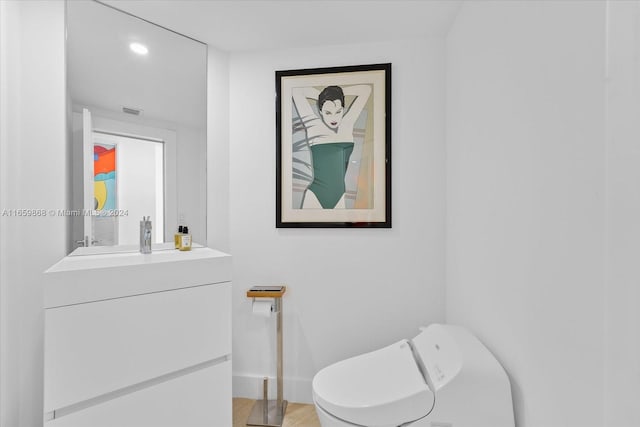 bathroom featuring vanity and toilet