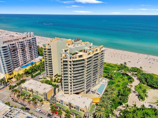 aerial view with a water view and a beach view