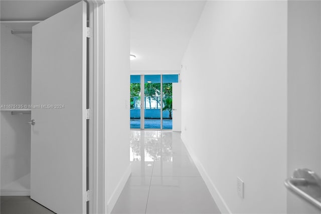 hallway with light tile patterned floors and expansive windows