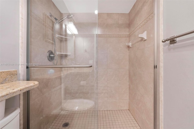 bathroom with toilet and walk in shower