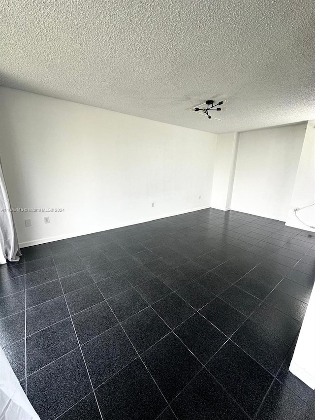 empty room featuring a textured ceiling