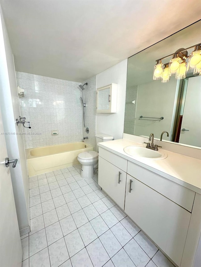 full bathroom featuring tile patterned floors, vanity, toilet, and tiled shower / bath