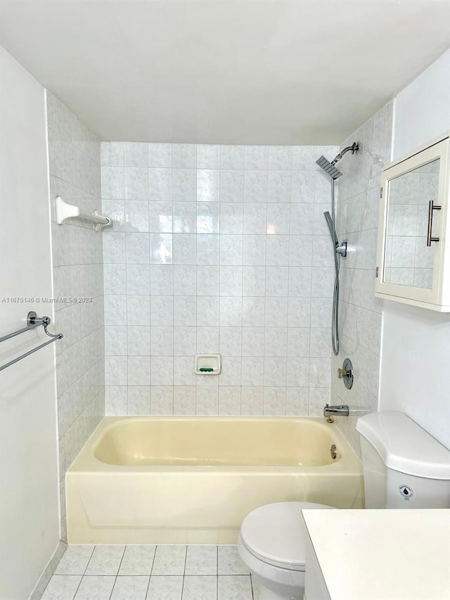 full bathroom with tiled shower / bath, vanity, tile patterned flooring, and toilet