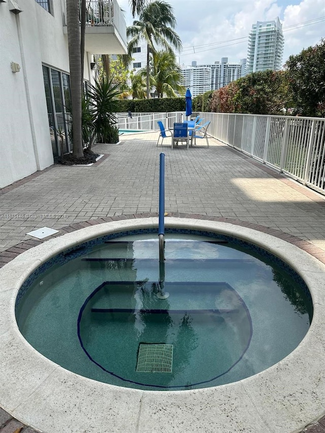 view of swimming pool with a patio and sink