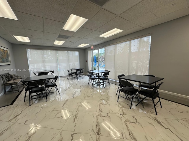 dining room with a drop ceiling