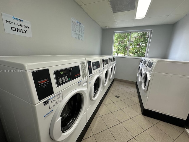 laundry room featuring washer and dryer and light tile patterned floors