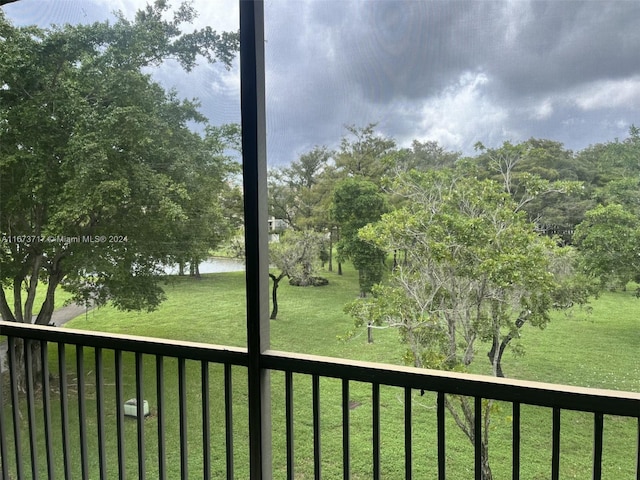 view of yard featuring a water view and a balcony