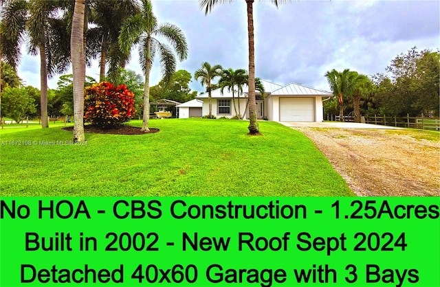 view of front of home featuring a front yard and a garage