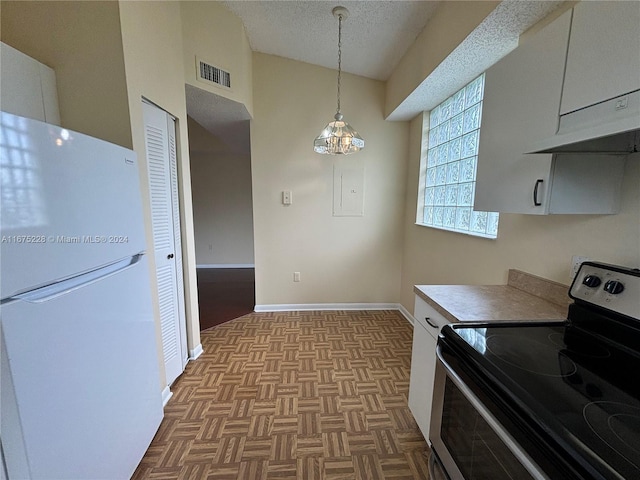 kitchen with stainless steel electric range oven, white fridge, light parquet flooring, and white cabinetry