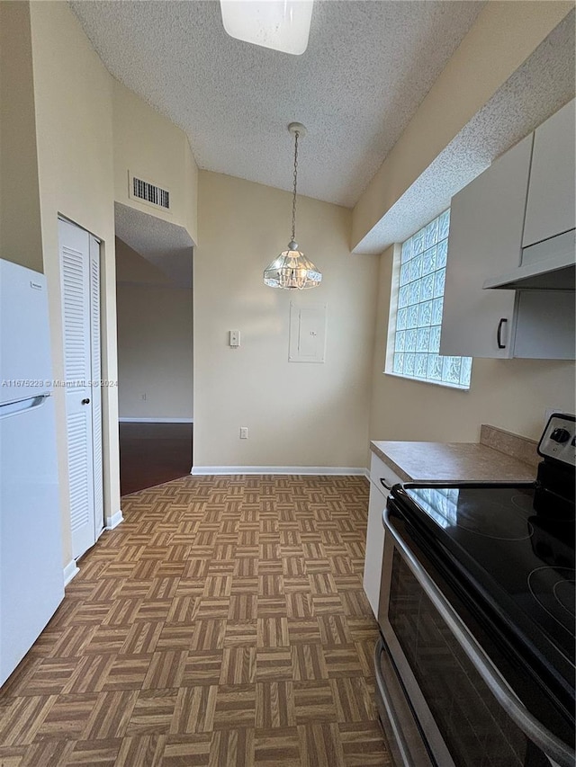 kitchen with pendant lighting, white cabinetry, light parquet floors, electric stove, and white fridge