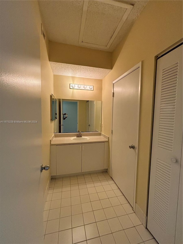 bathroom featuring tile patterned flooring and vanity