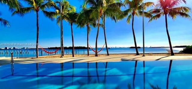 view of swimming pool featuring a water view