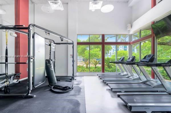 workout area featuring a towering ceiling