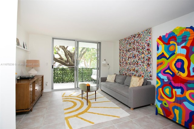 living area featuring a wall of windows and light tile patterned floors