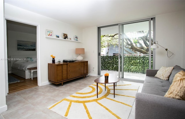 interior space with light tile patterned floors, baseboards, and a wall of windows