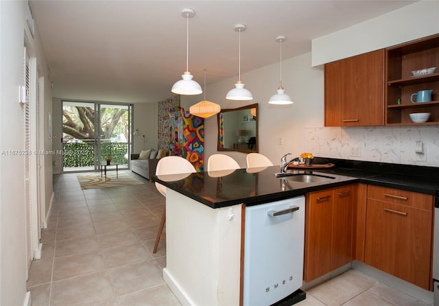 kitchen with a peninsula, a sink, dishwasher, open shelves, and dark countertops