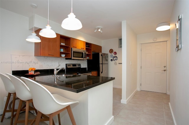 kitchen with pendant lighting, open shelves, a peninsula, and stainless steel appliances