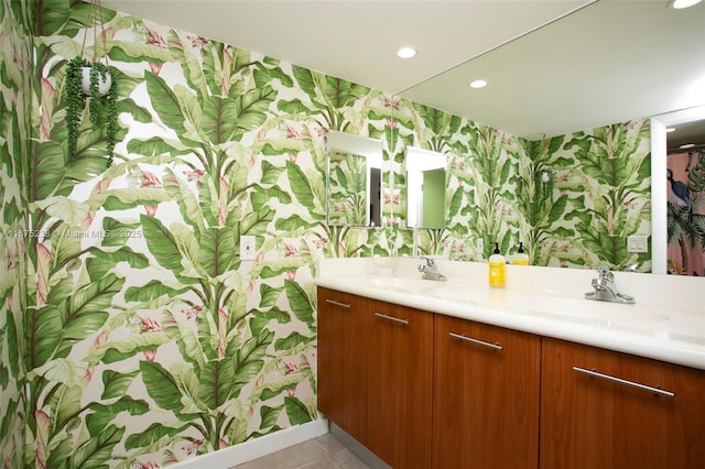 bathroom with double vanity, wallpapered walls, a sink, and recessed lighting