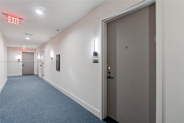 hall featuring carpet flooring