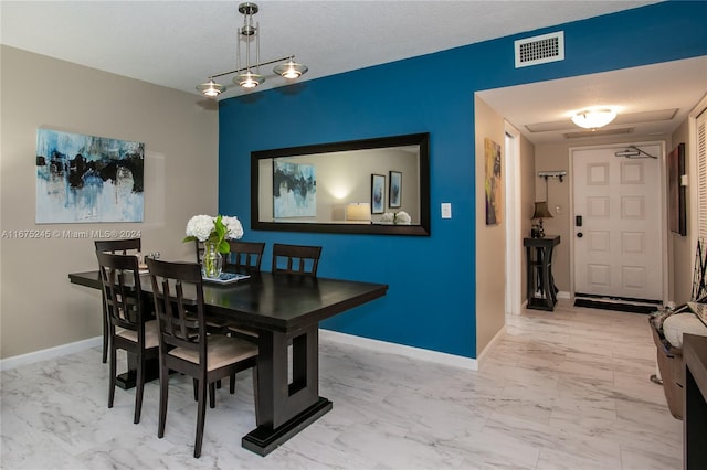 dining room featuring a textured ceiling