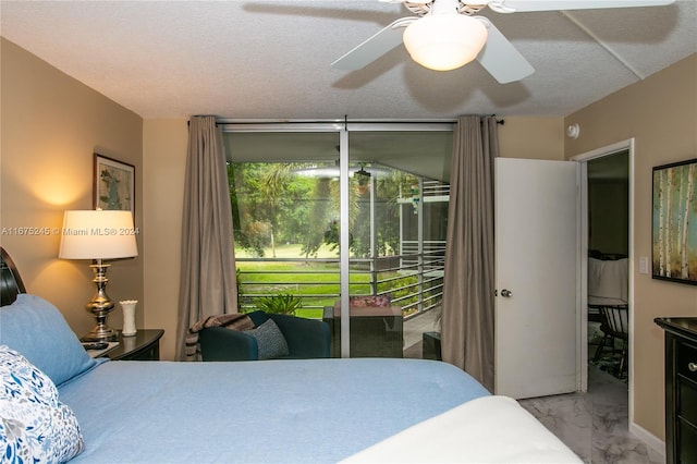 bedroom with a textured ceiling and ceiling fan