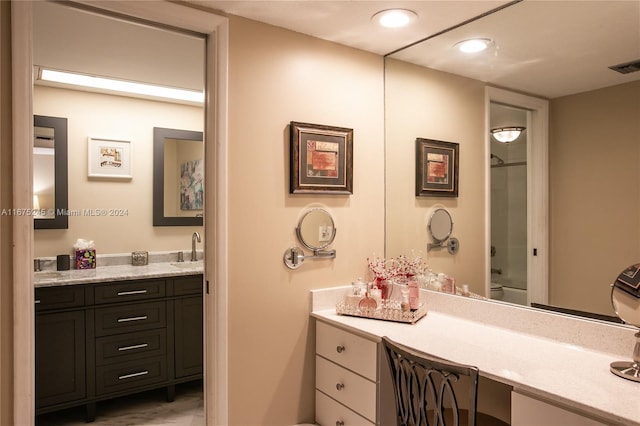 bathroom featuring walk in shower and vanity