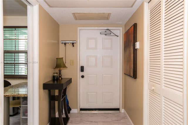 doorway featuring a textured ceiling