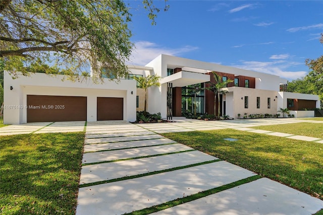 contemporary house with stucco siding, a front lawn, and driveway