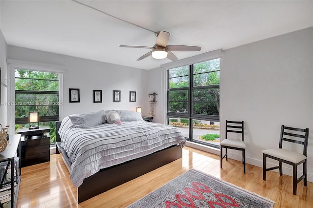 bedroom with ceiling fan and light hardwood / wood-style floors