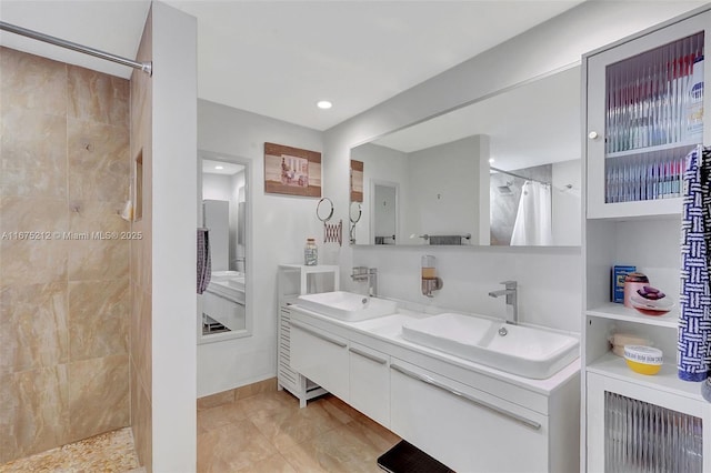 bathroom with vanity, tile patterned floors, and walk in shower