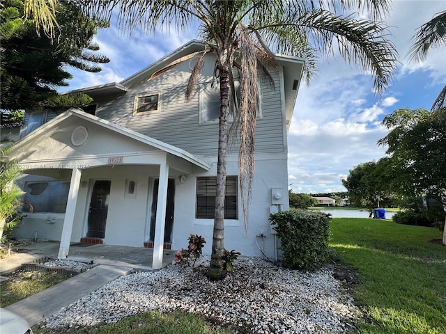 view of front of property with a porch and a front yard