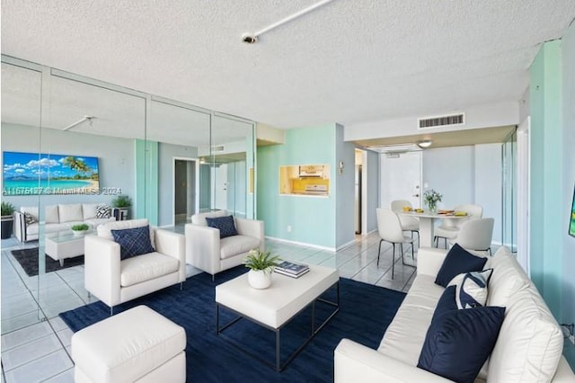 tiled living room featuring a textured ceiling